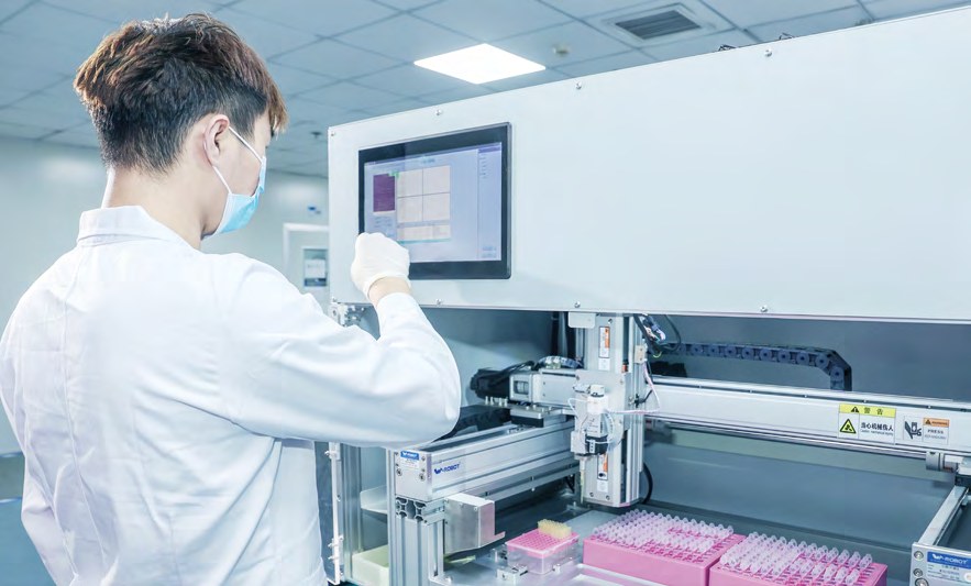 Technician operating a laboratory instrument (photo)